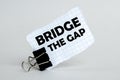 White paper on the white background with text Bridge The Gap Royalty Free Stock Photo