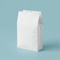 A white paper bag stands upright against a light blue background. The bag is Royalty Free Stock Photo