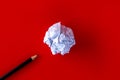 White paper ball with a black pencil on a red background. Royalty Free Stock Photo