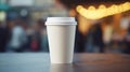 White paper biodegradable disposable cup with lid for hot drinks on a wooden table of street cafe. Tea or coffee to take Royalty Free Stock Photo