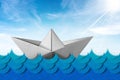 White paper boat in the blue waves of the sea Royalty Free Stock Photo