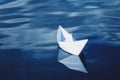 White paper boat floating in blue sea Royalty Free Stock Photo