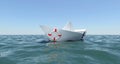 White paper boat floating in the sea water Royalty Free Stock Photo