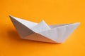 White paper boat on orange background close-up Royalty Free Stock Photo