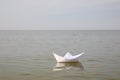 White paper boat on water surface, space for text Royalty Free Stock Photo