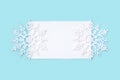 White paper card decorated with snowflakes on light blue background. Royalty Free Stock Photo