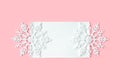 White paper card decorated with snowflakes on pink background. New Year, Christmas and winter concept. Flat lay, top view, free Royalty Free Stock Photo