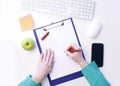 White paper on clipboard and woman`s hand holding pen while ready to write something Royalty Free Stock Photo