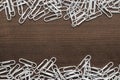 White paper clips on the wooden table