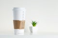 White Paper Cup and green potted plant Royalty Free Stock Photo