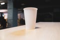 White paper cup on a table in an office center Royalty Free Stock Photo