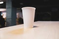White paper cup on a table in an office center Royalty Free Stock Photo