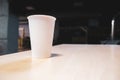 White paper cup on a table in an office center Royalty Free Stock Photo