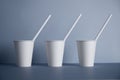 White paper cups isolated on gray mockup set Royalty Free Stock Photo