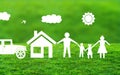 White Paper cut family with house and Car Standing Together on natural Grass in Blurry nature Background Royalty Free Stock Photo