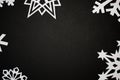 White paper cut out snowflakes on black background Royalty Free Stock Photo