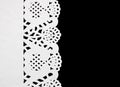 White paper doily on black background. Royalty Free Stock Photo