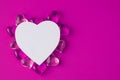 White paper heart with glass pink hearts on a pink pastel background. Mockup. Top view, flat lay. Valentine's day Royalty Free Stock Photo