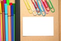 White paper on kraft notebook with markers and clips Royalty Free Stock Photo