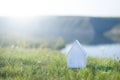 White paper little on green grass. Defocused background