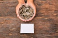 White paper mock up and stack coins in glass put on hand for save money and financial, tax season Royalty Free Stock Photo