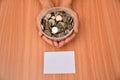 White paper mock up and stack coins in glass put on hand for save money and financial, tax season Royalty Free Stock Photo