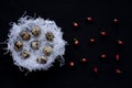 White paper nests with quail easter eggs, red berries of hypericum on a black background. Symbol of celebration of a religious