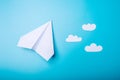 White paper origami airplane lies on pastel blue background Royalty Free Stock Photo