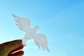 White paper origami bird on blue sky background Royalty Free Stock Photo