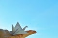 White paper origami bird on blue sky background Royalty Free Stock Photo