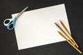 White paper, pencils and scissors on black background Royalty Free Stock Photo