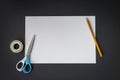 White paper, pencils and scissors on black background Royalty Free Stock Photo