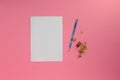 white paper on a pink background as copy space, next to the sheet a pencil with a sharpener ready to write Royalty Free Stock Photo