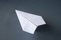 White paper plane origami isolated on a grey background Royalty Free Stock Photo