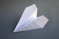 White paper plane origami isolated on a grey background Royalty Free Stock Photo