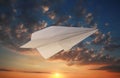White paper plane and view of beautiful sky at sunset Royalty Free Stock Photo