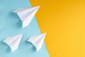 White paper planes on blue and yellow background composition Royalty Free Stock Photo