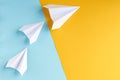 White paper planes on blue and yellow background composition Royalty Free Stock Photo