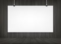 White paper poster hanging with wooden room space background. Royalty Free Stock Photo