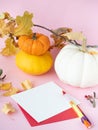 White paper on red envelope with autumn leaves and pumpkins around Royalty Free Stock Photo