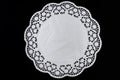 White paper round lace doily, on black background