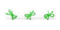 White paper scroll tied with cord, three green knots Royalty Free Stock Photo