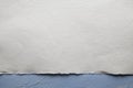 White paper sheet on plastered wall background Royalty Free Stock Photo