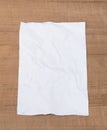 White paper sheet, paper crumpled on a wooden floor