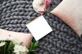 White paper sheet on the gray knitted blanket from merino wool Royalty Free Stock Photo