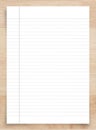White paper sheet on wood with clipping path. White notebook paper with line pattern background Royalty Free Stock Photo
