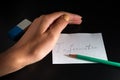 White paper sheet with word `Information` and pencil are on the black background. Female hand is protecting information, near is e