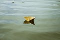 A white paper ship floating on water Royalty Free Stock Photo