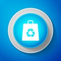 White Paper shopping bag with recycle symbol icon isolated on blue background. Circle blue button with white line Royalty Free Stock Photo