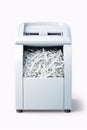 A white paper shredder placed on a table. Can be used for office or document security concepts